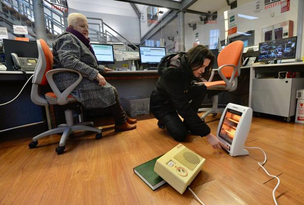 Usuarios y empleados de la biblioteca Río Segura de Murcia combaten el frío con abrigos