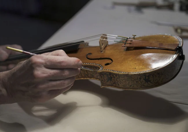 Neumann aplica barniz al Stradivarius decorado del Palacio Real.