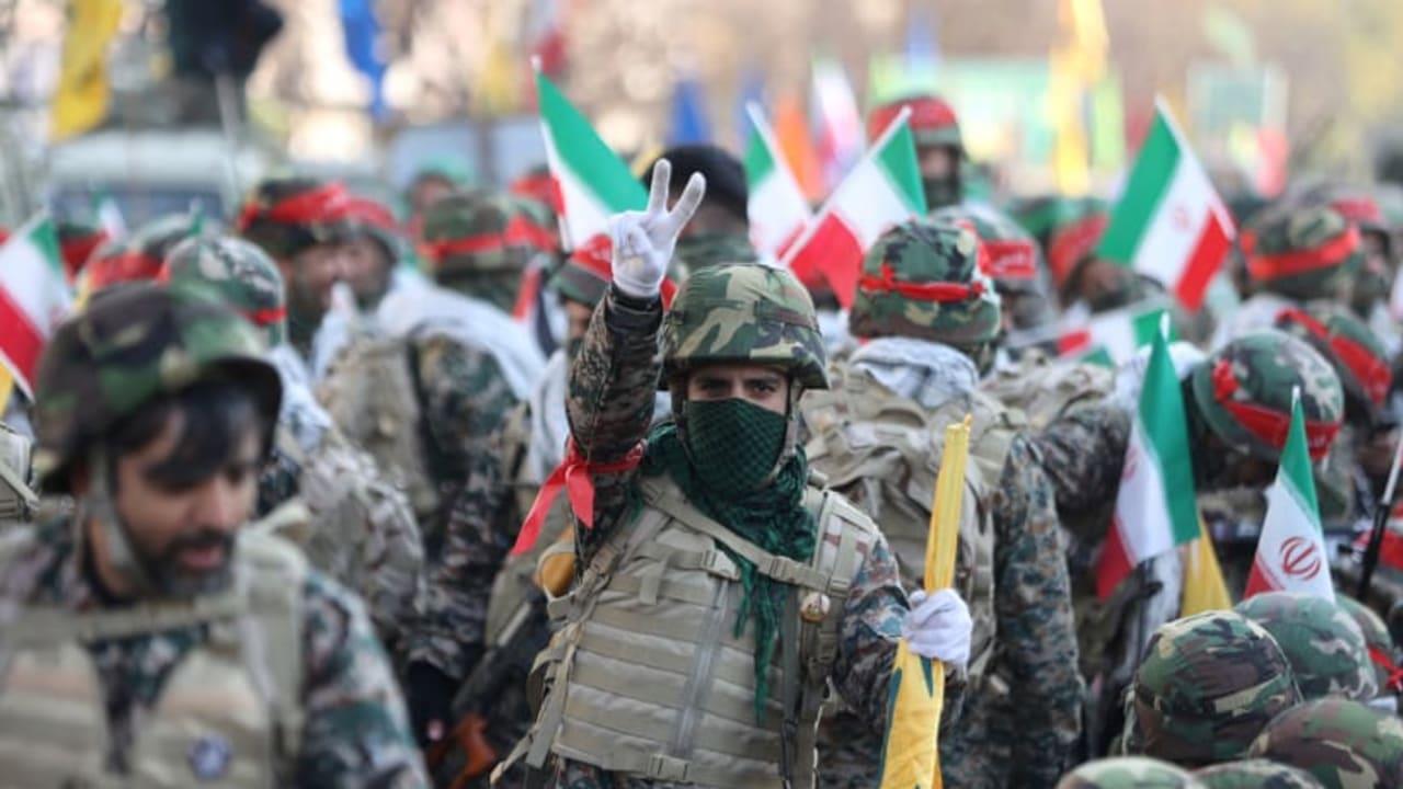 Un miembro de la Fuerza Basij iraní hace el signo de la victoria durante un desfile en Teherán.